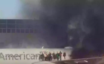 American Airlines plane bursts into flames forcing passengers onto aircraft wing